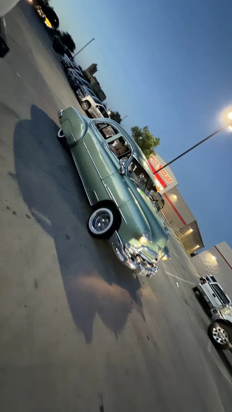 Sage green classic lowrider bomber with whitewall wheels at Hemphill & Seminary