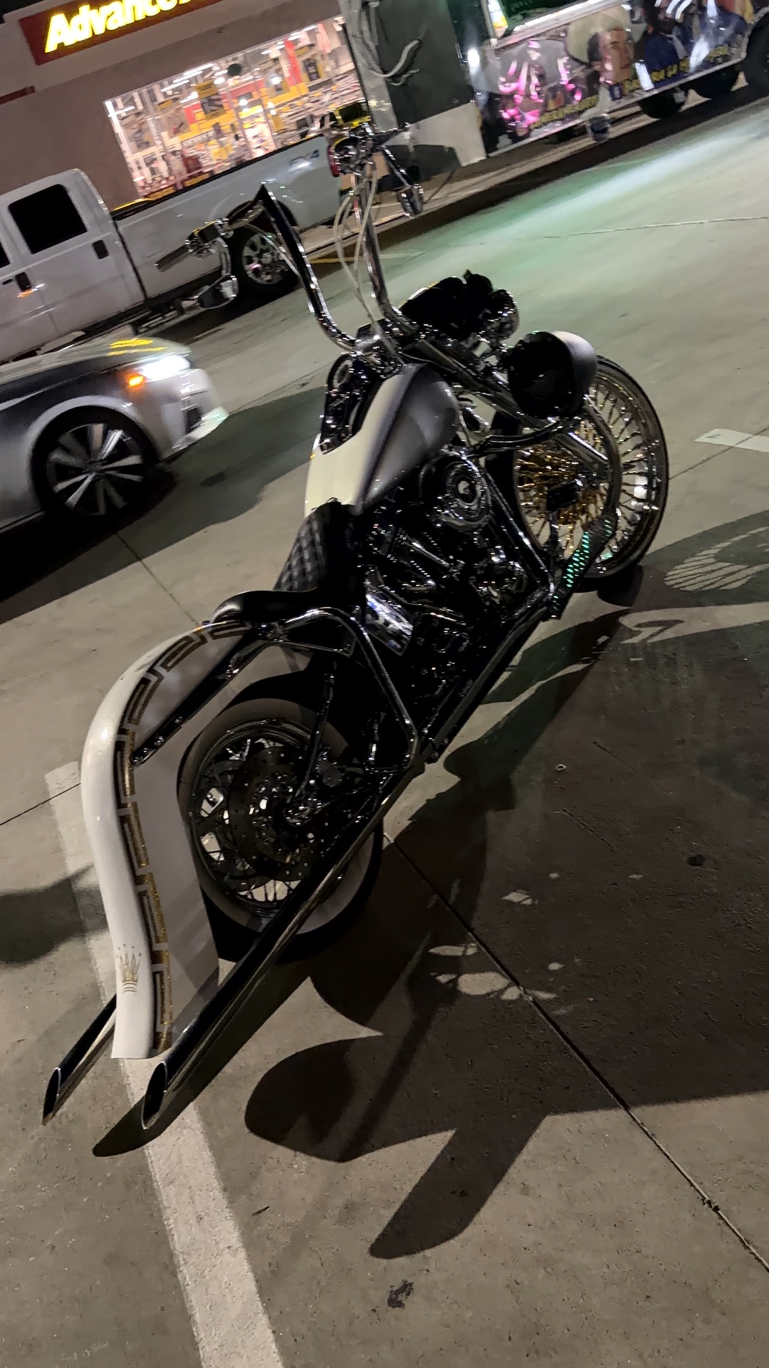 Detailed custom bike with extended chrome handlebars and gold spoke wheel